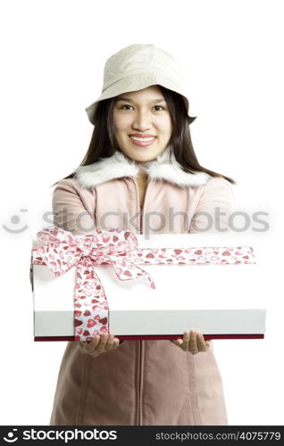 A woman carrying a gift box with pink ribbon