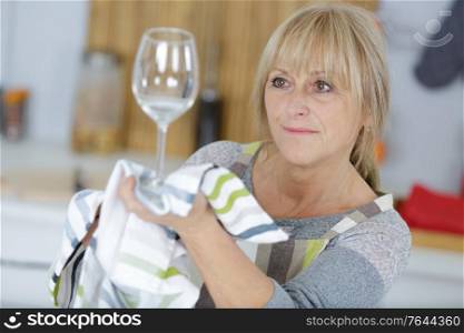 a woman cleaning wine glass