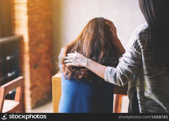 A woman comforting and giving encouragement to her sad friend