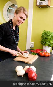 A woman cutting vegetables at home on the counter