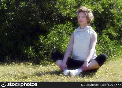 A woman doing stretching exercises in a park. woman, adult, alone, beauty, casual, female, blonde, fitness, exercise, yoga, stretching, location, time out, holiday, active, fit, lifestyle, good lo...