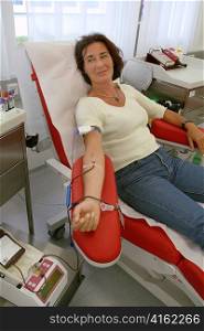 a woman donates blood at a blood bank. saving lives through blood donations.