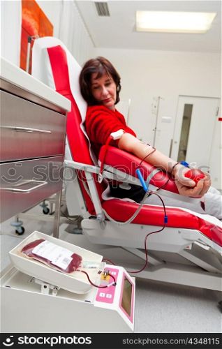 a woman donates blood at a blood bank. saving lives through blood donations.