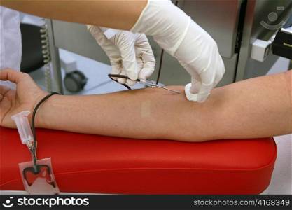 a woman donates blood at a blood lab. blood transfusions can save lives.