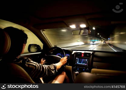 a woman drives her car into a tunnel