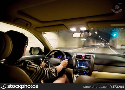 a woman drives her car into a tunnel