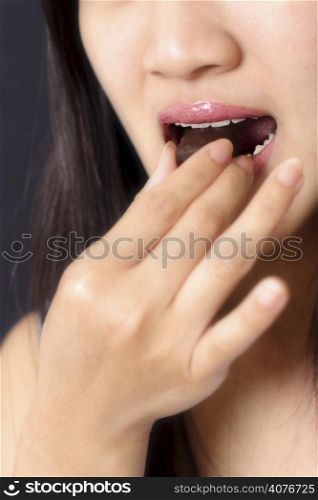 A woman eating a chocolate