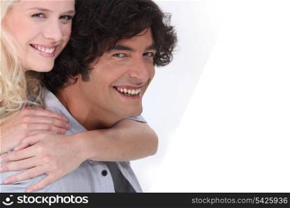 a woman embracing a man, both are laughing