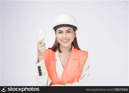 a woman engineer wearing a protective helmet over white background studio