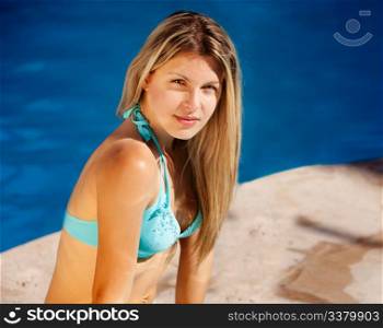 A woman enjoying the sun at an outdoor pool