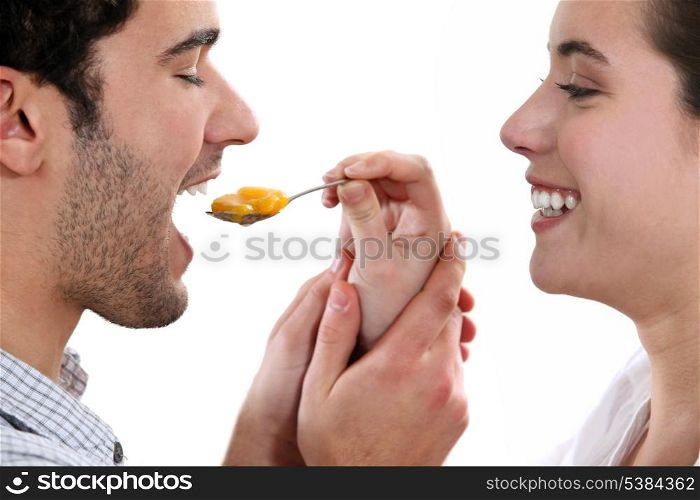 A woman feeding her man.