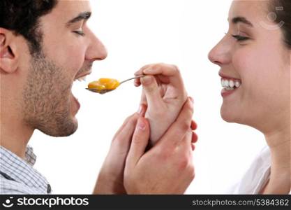 A woman feeding her man.