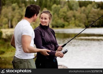 A woman fishing - showing a man