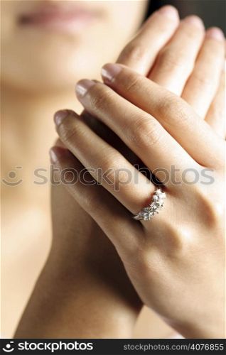 A woman hand wearing a diamond ring