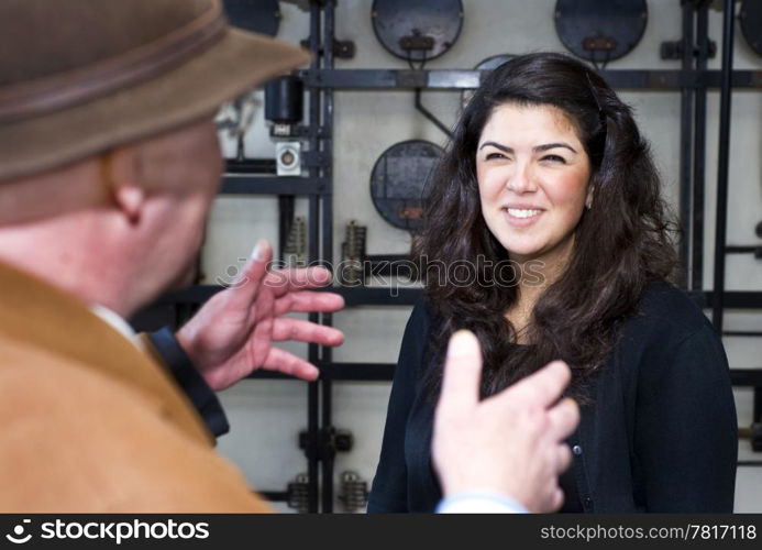 A woman, happy to see a friend, who&rsquo;s approaching her with outstretched hands