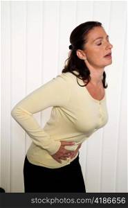 a woman has abdominal pain in the office. engages with the hands on the belly.
