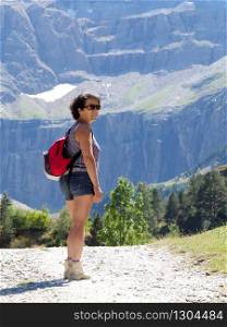 A woman hiker and cirque de Gavarnie in the French pyrenees mountains