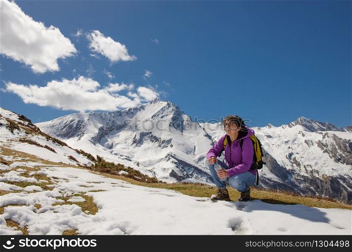a woman hiker in the French Pyrenees in spring with snow, col du Soulor