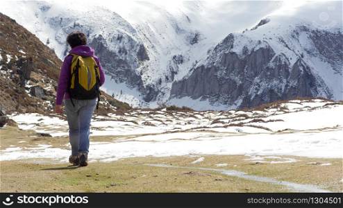 a woman hiker in the French Pyrenees with backpack in spring, col du Soulor