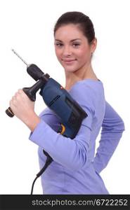 A woman holding a drill.