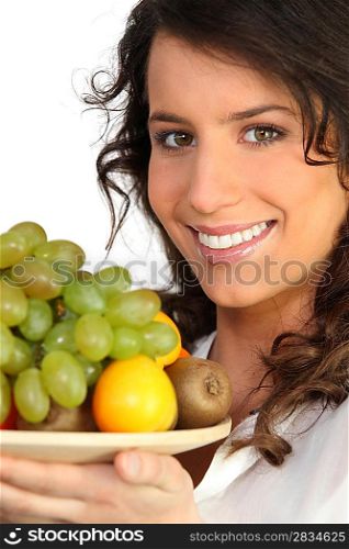 a woman holding a fruits plate