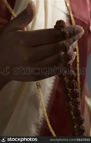 A woman holding a rosary