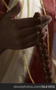 A woman holding a rosary