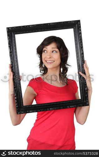 a woman holding a wooden frame