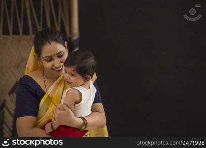 A woman holding her baby with affection.