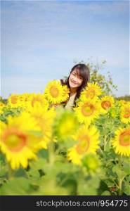 A woman in a field of sunflowers.
