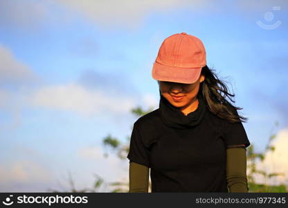 A woman in a hat is smiling with happiness