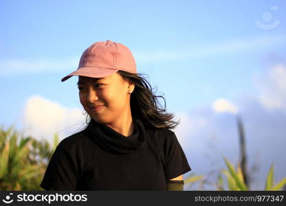 A woman in a hat is smiling with happiness