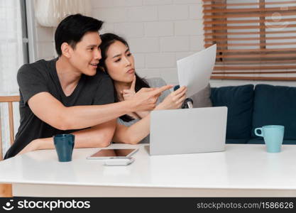 A woman in a wheelchair after a car accident and working with a computer at home with her lover. The concept of Mutual care and new technology has made people with disabilities Equality in society.