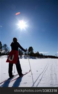 A woman in a winter landscape cross country skiing