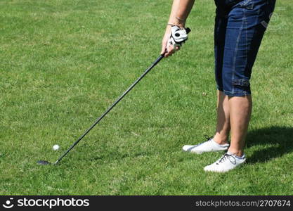 A woman in golf position, holding a golfclub