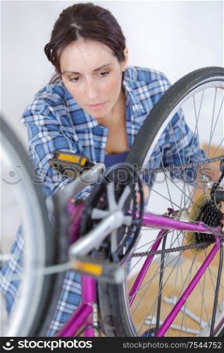 a woman inspecting a bike