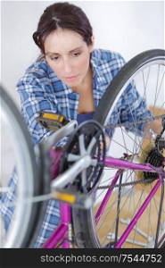a woman inspecting a bike