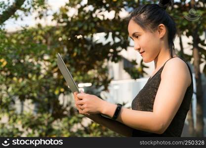 A woman is holding laptop computer to surfing internet