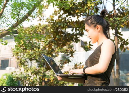 A woman is holding laptop computer to surfing internet