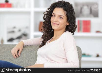 a woman is relaxing in sofa
