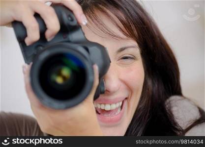 a woman is using a camera