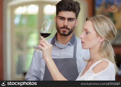 a woman is wine tasting