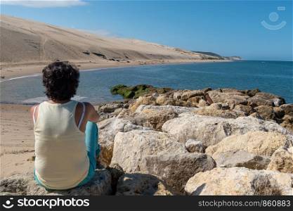 a woman looking at the ocean near the Dune du Pilat