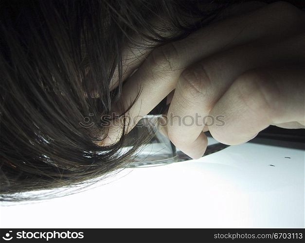 A woman looks closely at her photographs on a light box at a photographic studio. Melbourne Australia.