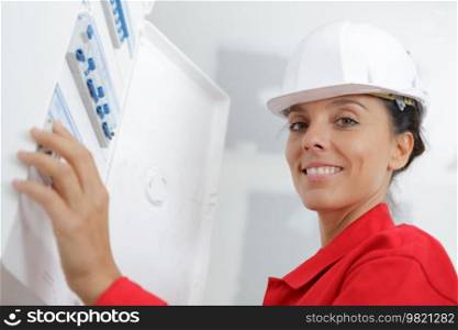 a woman measuring electrical current