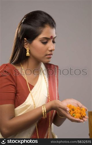 A woman offering flowers