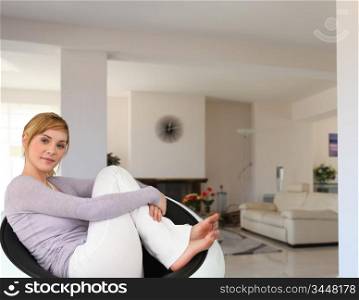 A woman on a chair in her living room.