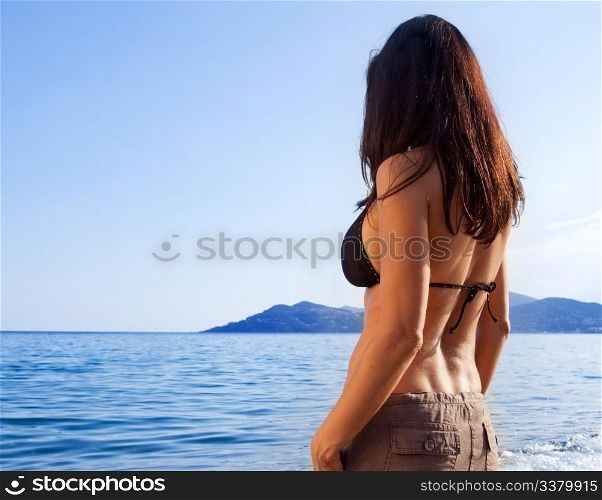 A woman on a holiday looking out at the ocean