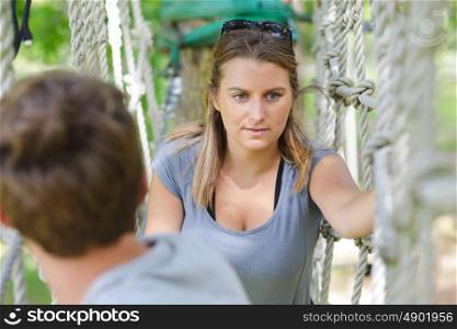 a woman on a rope bridge