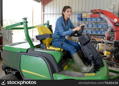 a woman operating the tractor